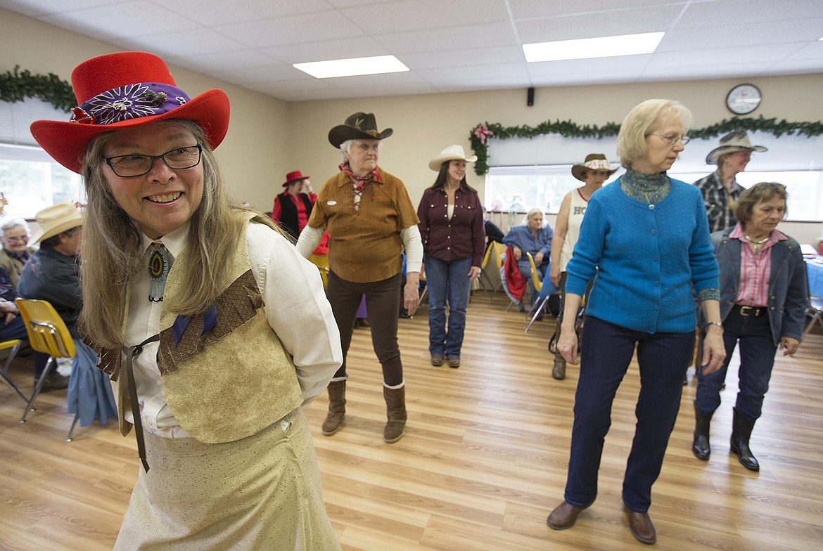 LISA JAMES/Press
Lyn Haney watches instructions as she gets ready to line dance with fellow members of BAB&#146;s (Bayview Athol Belmont) during their Wild West Social at the community center in Bayview on Tuesday.