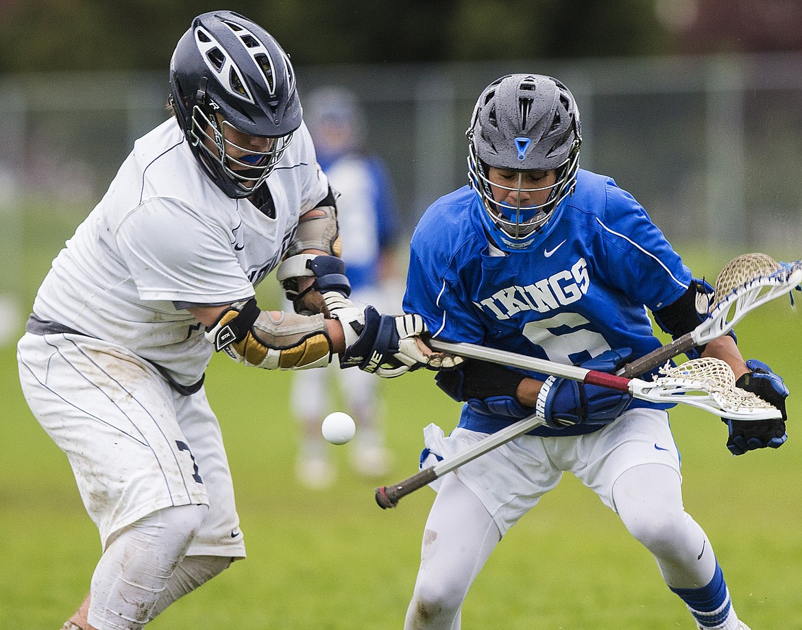 LOREN BENOIT/Press

Hunter Brett, right, of Coeur d&#146;Alene High and Lake City&#146;s Cameron Chun fight for possession of the ball at midfield in the 5A North Idaho Championship lacrosse match Tuesday evening at Lake City High School.