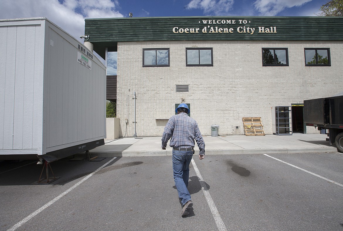 LISA JAMES/Press
LB Martin of Ginno Construction walks toward Coeur d&#146;Alene City Hall while doing work on Monday. City Hall is under renovation for the next few months. Changes are underway on the lower level and will include an expanded and more open lobby on the back side, as well as an elevator from the new lobby.