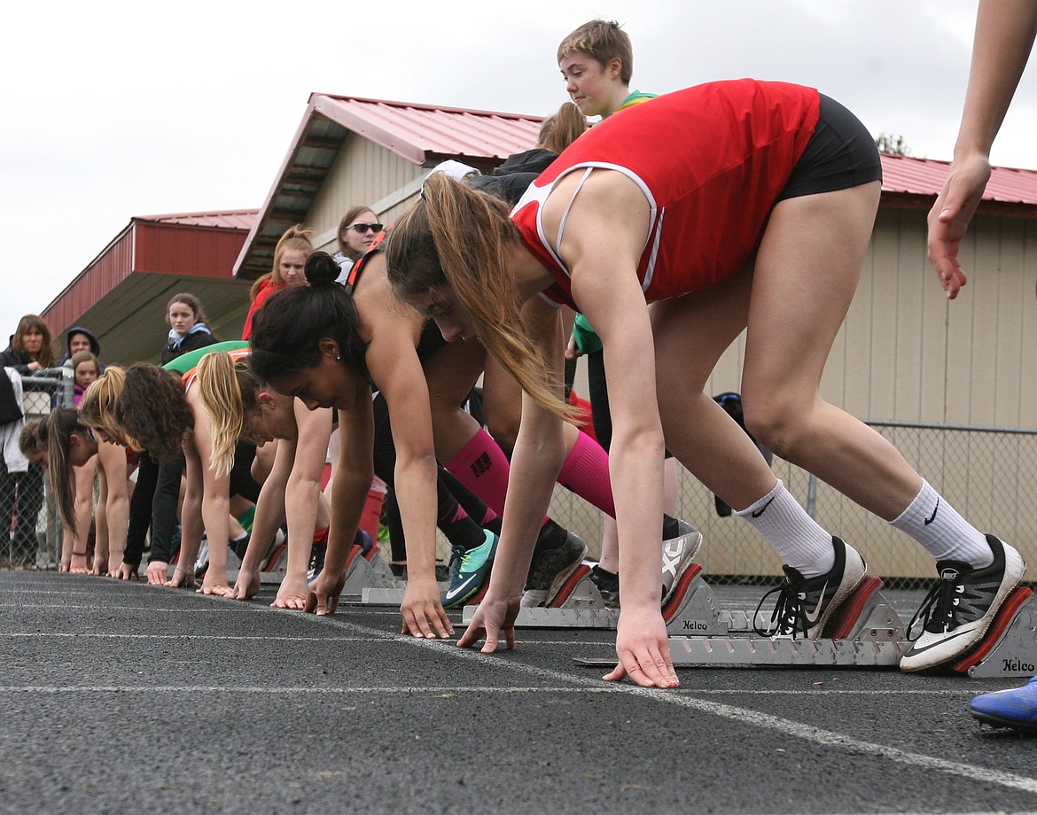 (Photo by ERIC PLUMMER)
Sandpoint sophomore Jazmin Stockton, near in the starting blocks, is the lone Bulldog competing in four events, two sprints and two relays.