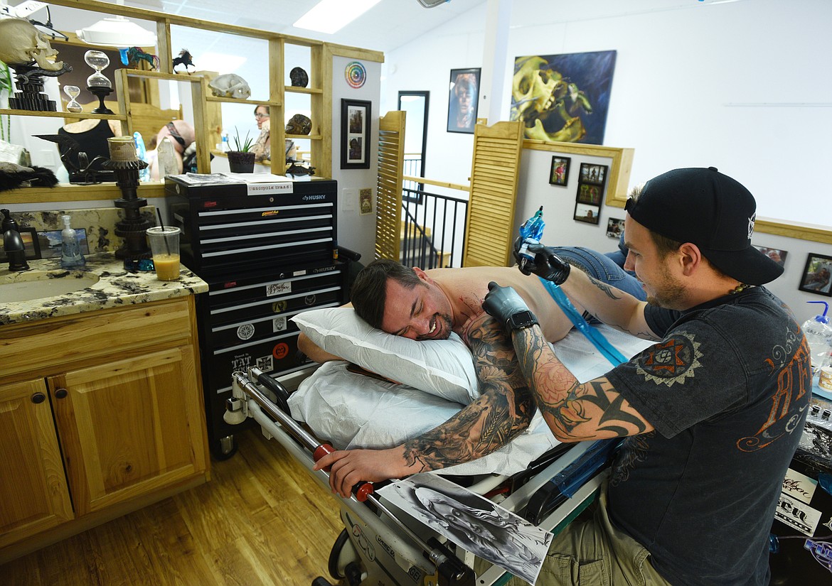 JAKE BERTELSEN does work on a tattoo sleeve for Shane Reece at Bertelsen Art and Tattoo. (Aaric Bryan/This Week in the Flathead)