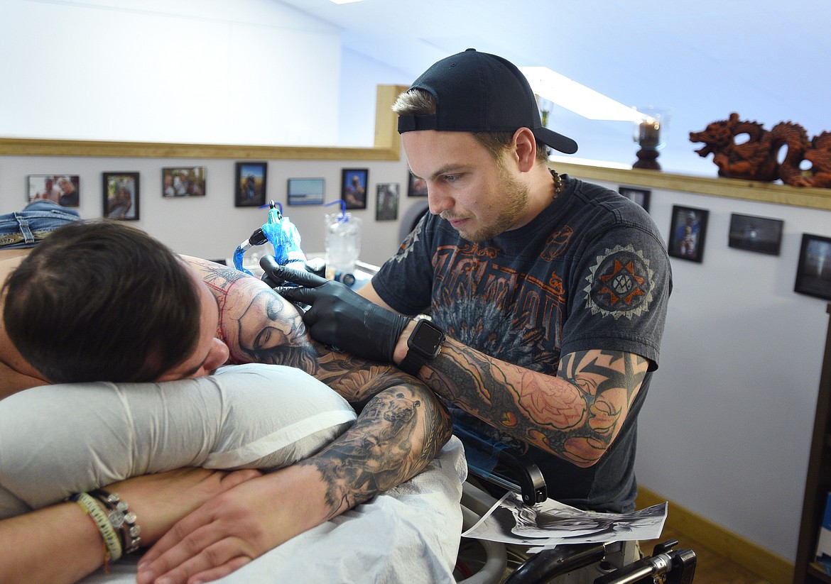 Jake Bertelsen does work on Shane Reece sleeve at Bertelsen Art and Tattoo. (Aaric Bryan/Daily Inter Lake)