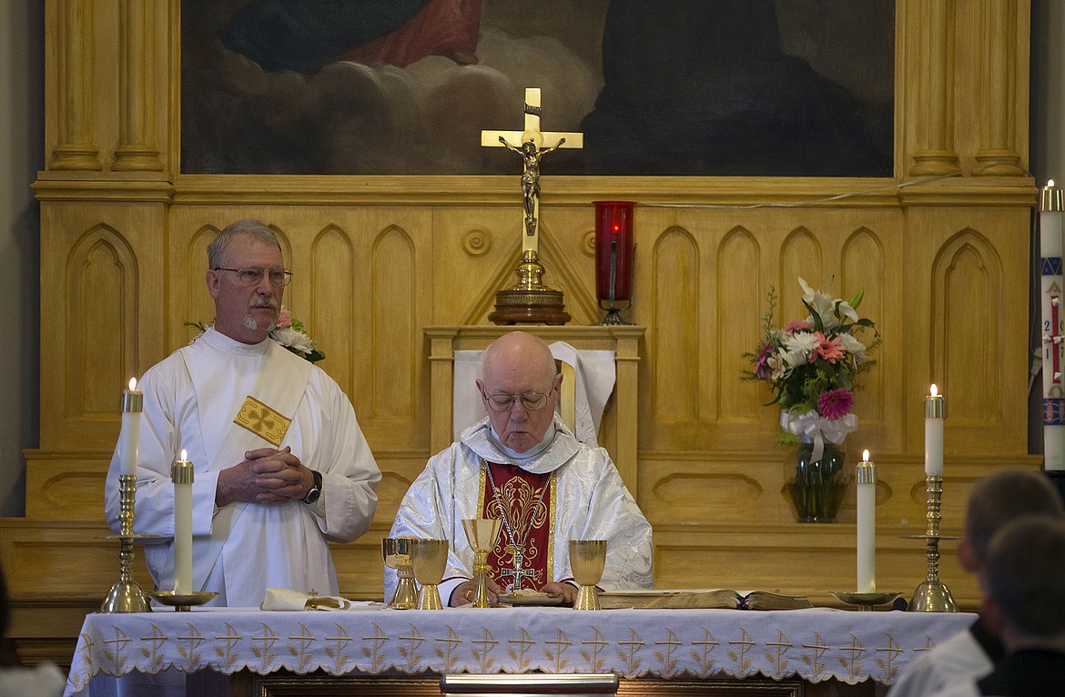 LISA JAMES/PressBishop Emeritus William Skylstad, right, and Deacon Erik Schirmer, begin the holy communion at St. Stanislaus Church in Rathdrum during a special mass for Mother's Day and the anniversary of Our Lady of Fatima.