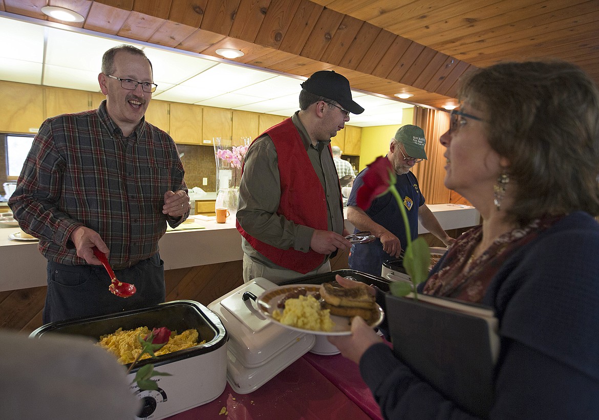 LISA JAMES/PressMembers of the Knights of Columbus from left: Paul Franz, Brian Roccapalumbo and Matthew Schueller serve the annual Mother's Day Breakfast they prepared for the mothers of St. Stanislaus Church in Rathdrum on Sunday.