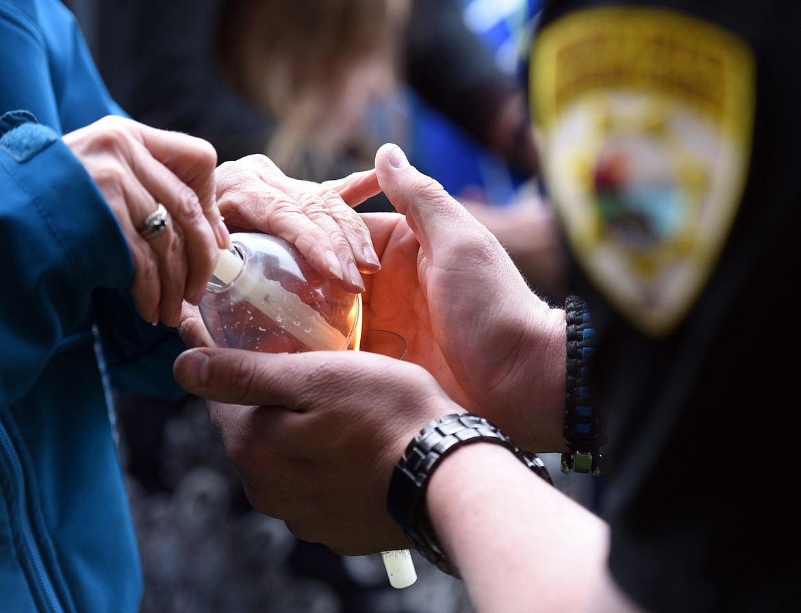 Candles are lit at the vigil for Broadwater Deputy Sheriff Mason Moore on Wednesday evening, May 17, outside the Flathead County Sheriff&#146;s Office in Kalispell.&#160;(Brenda Ahearn/Daily Inter Lake)