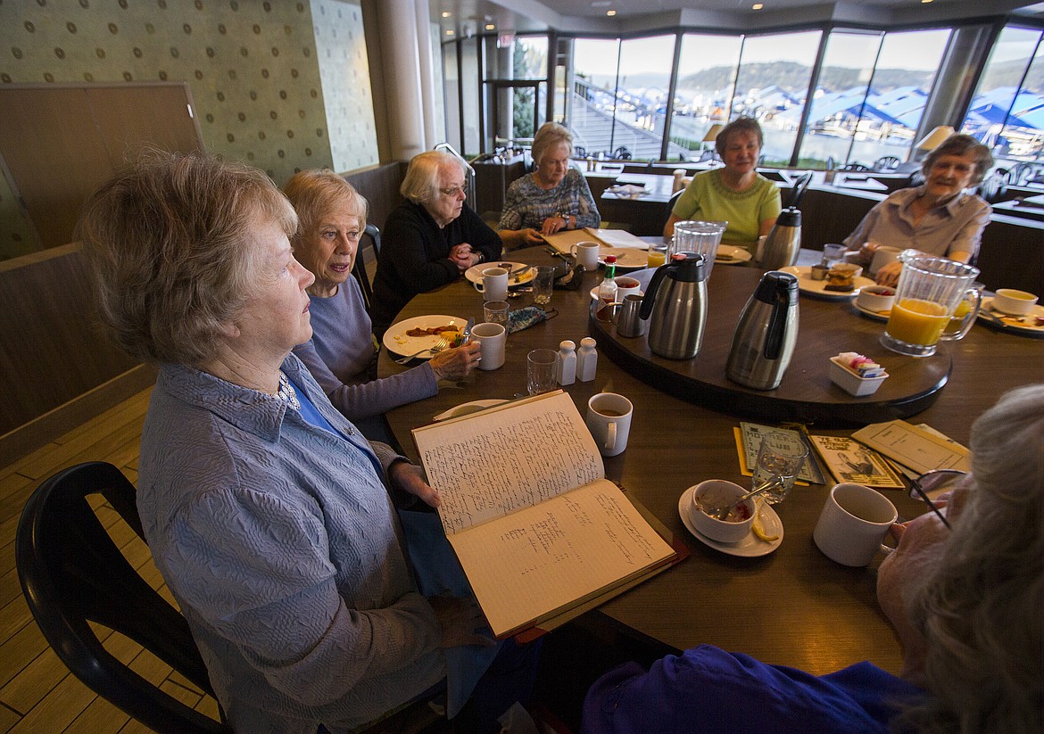 LOREN BENOIT/PressMary Brown, far left, holds a mothers club attendance ledger before passing it around the table at Dockside in early May 2017.