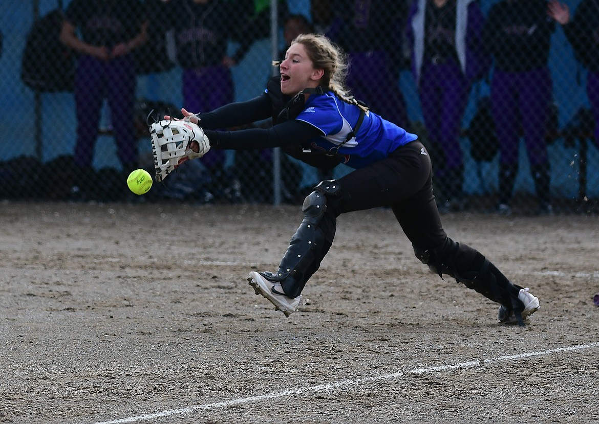 Columbia Falls catcher Hannah Freeman just misses a pop-up in front of the plate against Polson. Freeman had a home run to help lead the Wildkats to a win over conference rival Polson Tuesday night in Columbia Falls.