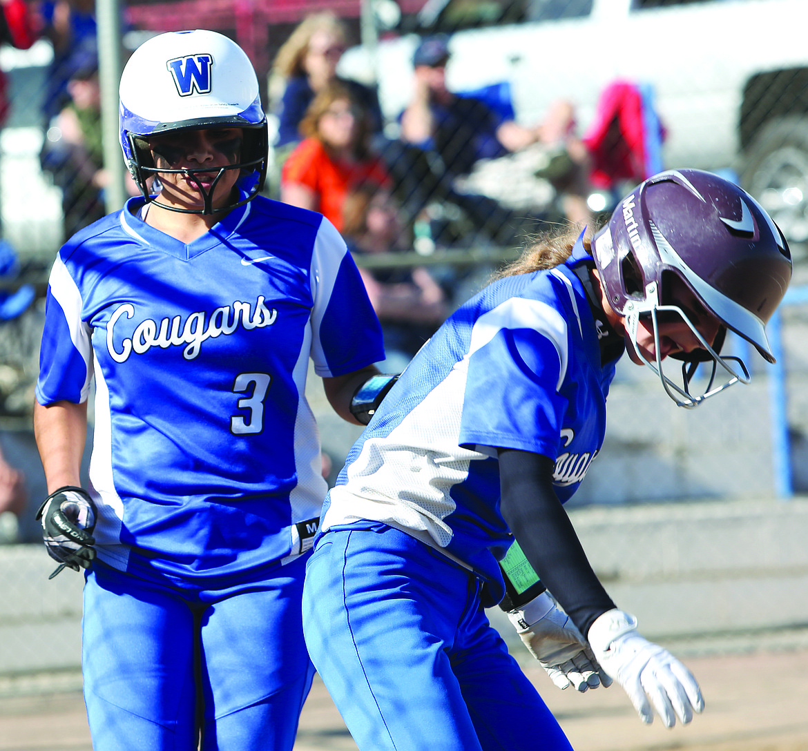 Connor Vanderweyst/Columbia Basin Herald
Jizelle Pruneda (3) and Leanne Martinez head to the dugout after scoring in the fourth inning.