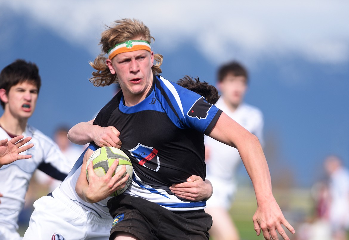Black and Blue&#146;s Sam Mann carries a Northern Idaho defender during the Black and Blue&#146;s 57-10 victory in the Montana Youth Rugby Championship at Glacier on Saturday. (Aaric Bryan/Daily Inter Lake)