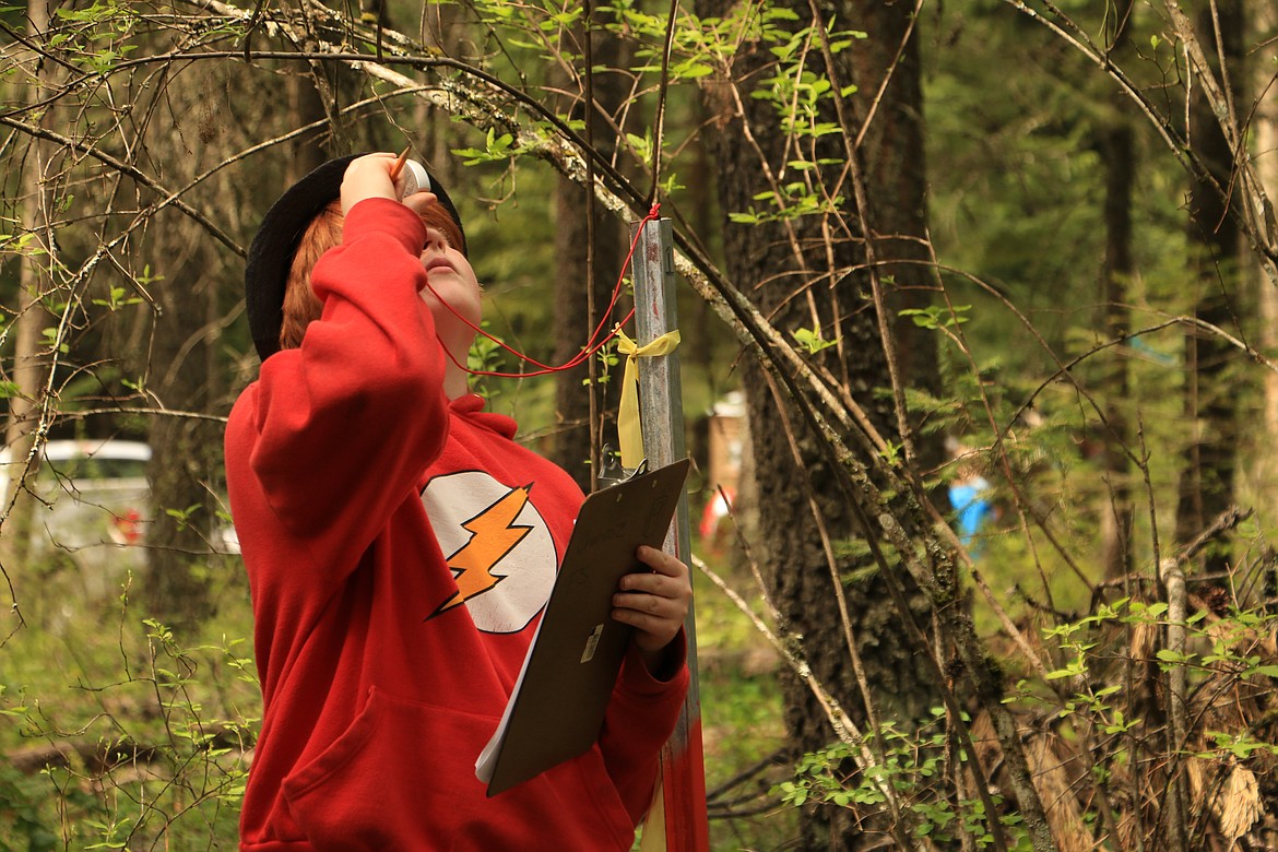 (Photo by MARY MALONE)
Cody Majeski, a sixth-grader at Farmin-Stidwell Elementary, peers through a Clinometer to determine the height of a tree in front of him during the 35th annual Idaho State Forestry Contest Thursday in Careywood.