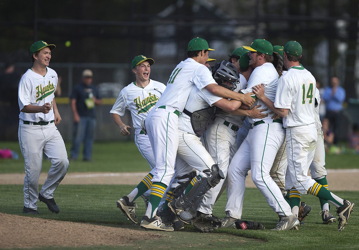 LISA JAMES/PressLakeland players pileup to celebrate their advance to the state championship following their 4A Region 1 baseball championship win over Sandpoint at Lakeland High School on Wednesday.