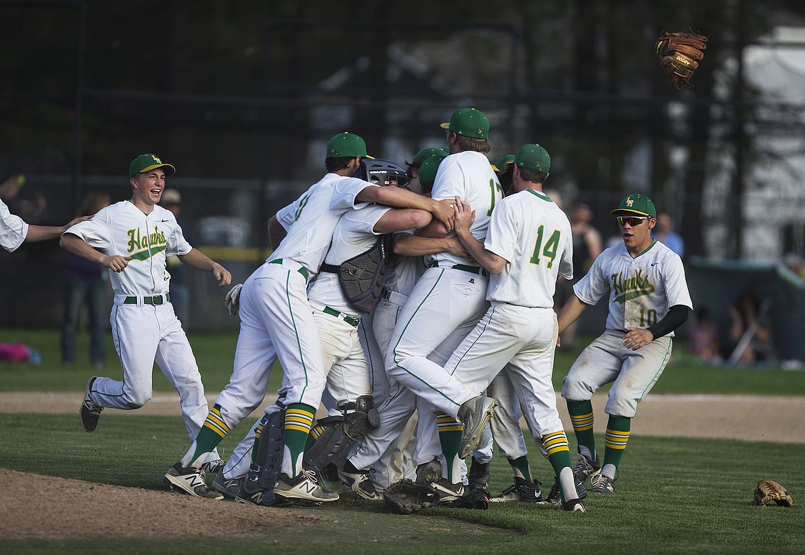 Lakeland players celebrate after qualifying for the state 4A baseball tournament following the Hawks&#146; 7-4 victory over Sandpoint at Lakeland High School on Wednesday. 
LISA JAMES/Press