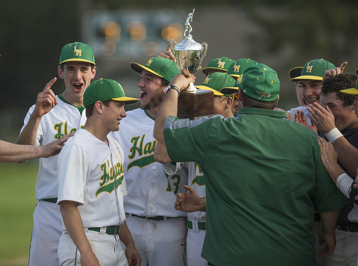 LISA JAMES/PressLakeland players hold up their  4A Region 1 baseball championship trophy after their win over Sandpoint at Lakeland High School on Wednesday. Lakeland now moves on to the state championships.
