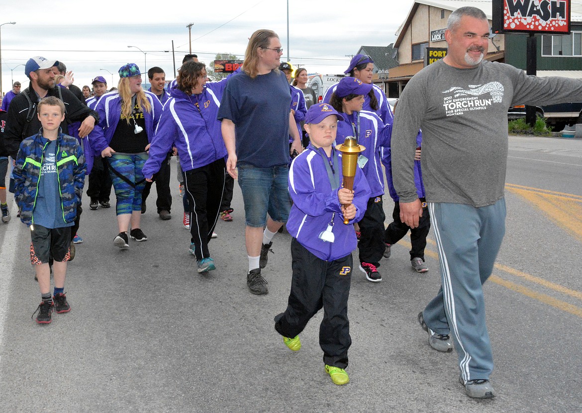 THE POLSON Special Olympics team and volunteers come through town for their annual torch run to commerate the beginning of the Montana State Special Olympics that begin with their opening ceromonies Wednesday night that will be held at the Adams Center at the University of Montana in Missoula. (Jason Blasco/Lake County Leader)