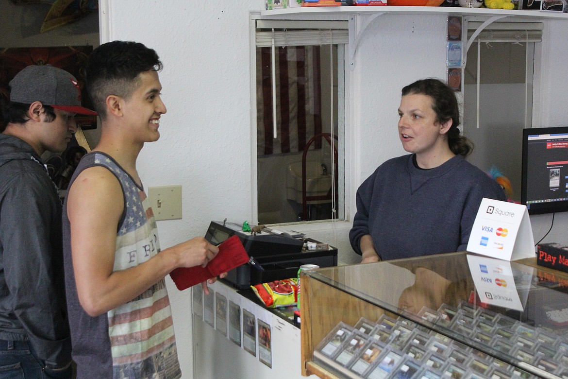 Richard Byrd/Columbia Basin Herald
Bridget Barajas, owner of Dragon&#146;s Game Cave, helps out customers.