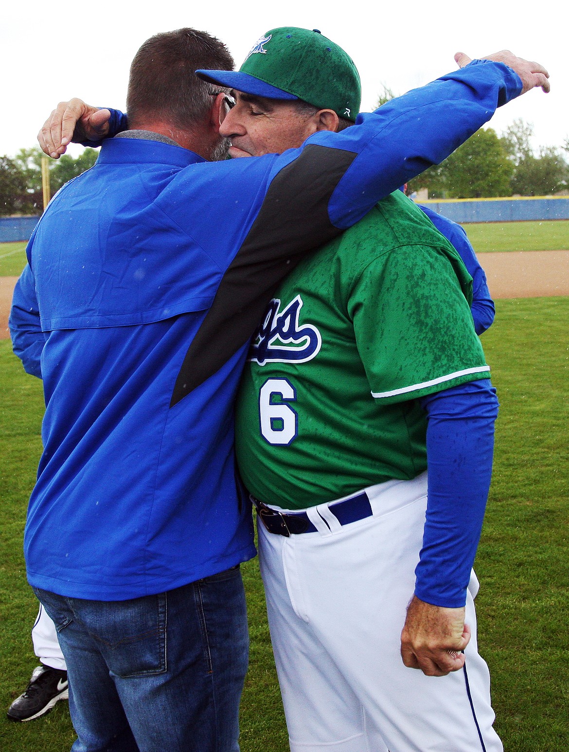 Rodney Harwood/Columbia Basin HeraldLongtime manager Pete Doumit gets a hug from former player B.J. Garbe during a ceremony on Saturday marking Doumit's final doubleheader with Big Bend Comunity College. Doumit is retiring after 45 years of coaching.