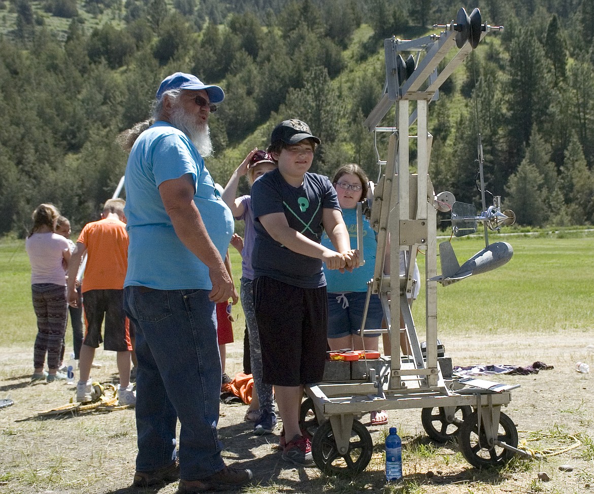 Hydrologist George McCloud with the CSKT Division of Water teaches a fourth grade student from Linderman Elementary how to use a crane-mounted water flow monitor during River Honoring last week, (Brett Berntsen/Lake County Leader)