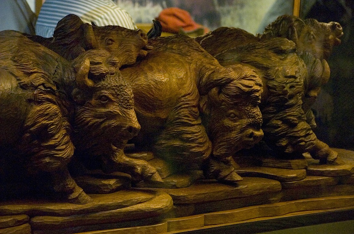 A CARVING by wood worker John Sharp and donated by Jim and Barbara Kackley of Wisconsin was unveiled at the National Bison Range visitor center on Friday.