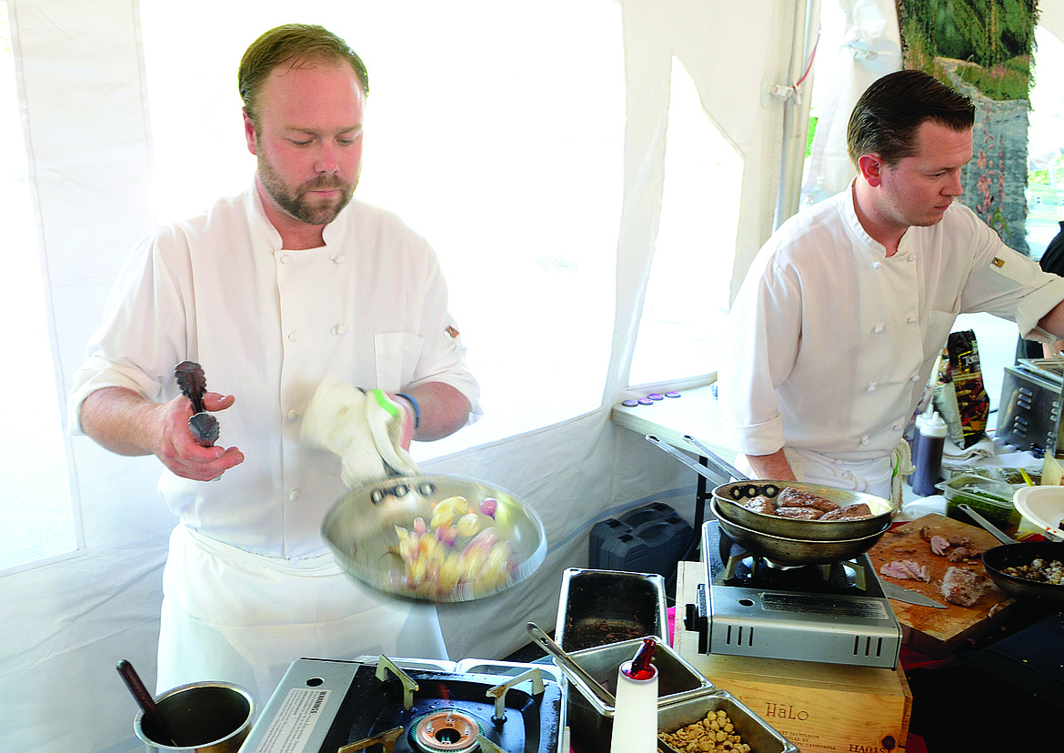 LATITUDE 48 Bistro chef Kevin Dodd sautes pearl onions and hazel nuts at the former Taste of Whitefish festival. (Matt Baldwin/Whitefish Pilot)