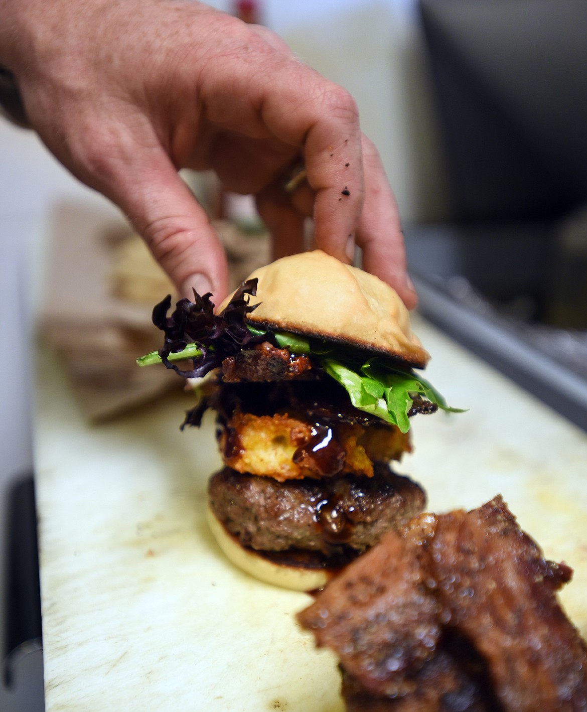 THE FINISHING touches are put on a burger at Piggyback BBQ in Whitefish.
(Brenda Ahearn/Daily Inter Lake)