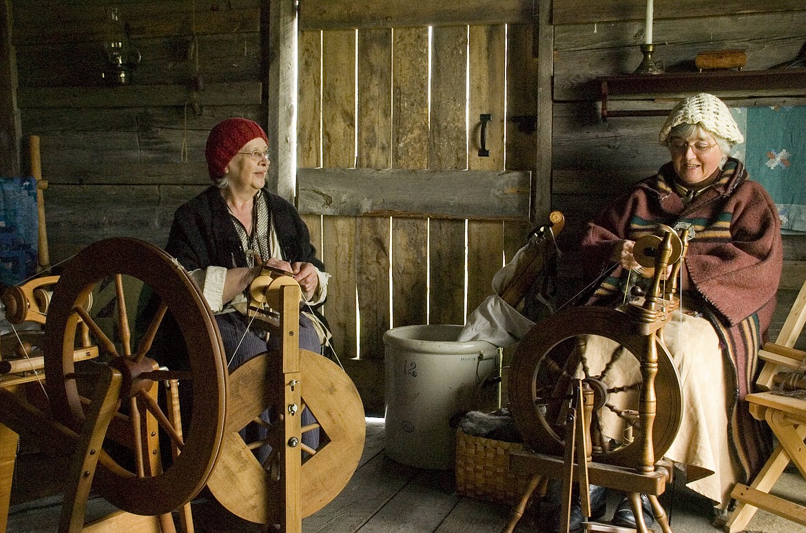 Donna Peck, left, and Mary Ellen Davis spin wool into yarn at the Fort Connah Spring Rendezvous Sunday.