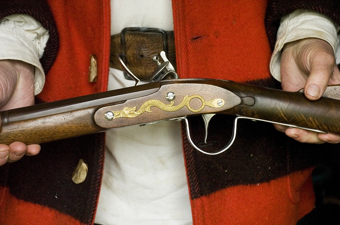 Ted Hoglund of Thompson Falls shows off a flintlock rifle popular on the American frontier during the Fort Connah Spring Rendezvous on Sunday. (Brett Berntsen/Lake County Leader)