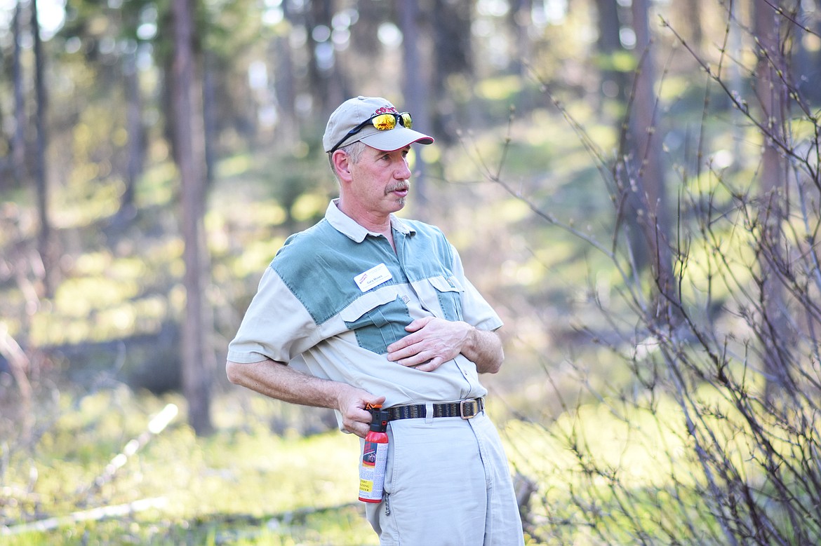 Retired Glacier National Park Ranger Gary Moses demonstrates how to shoot bear spray from the hip during a recent &#147;Bear Aware&#148; hike.