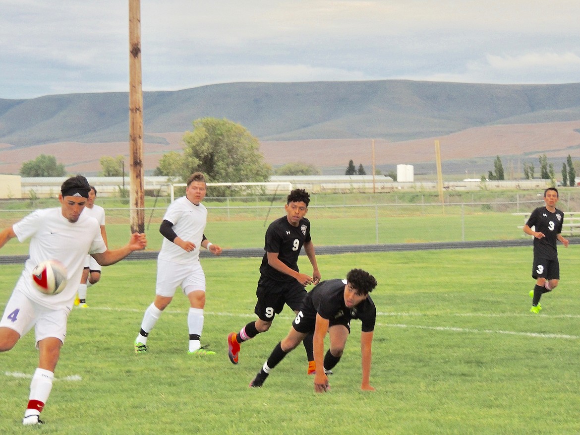 Ted Escobar/The Sun Tribune - The Wahluke attack crew of Manny Hidalgo (9), Tony Espindola (5) and Erick Perez (3) drop into a defensive posture as a Mabton defender gets control of the ball.