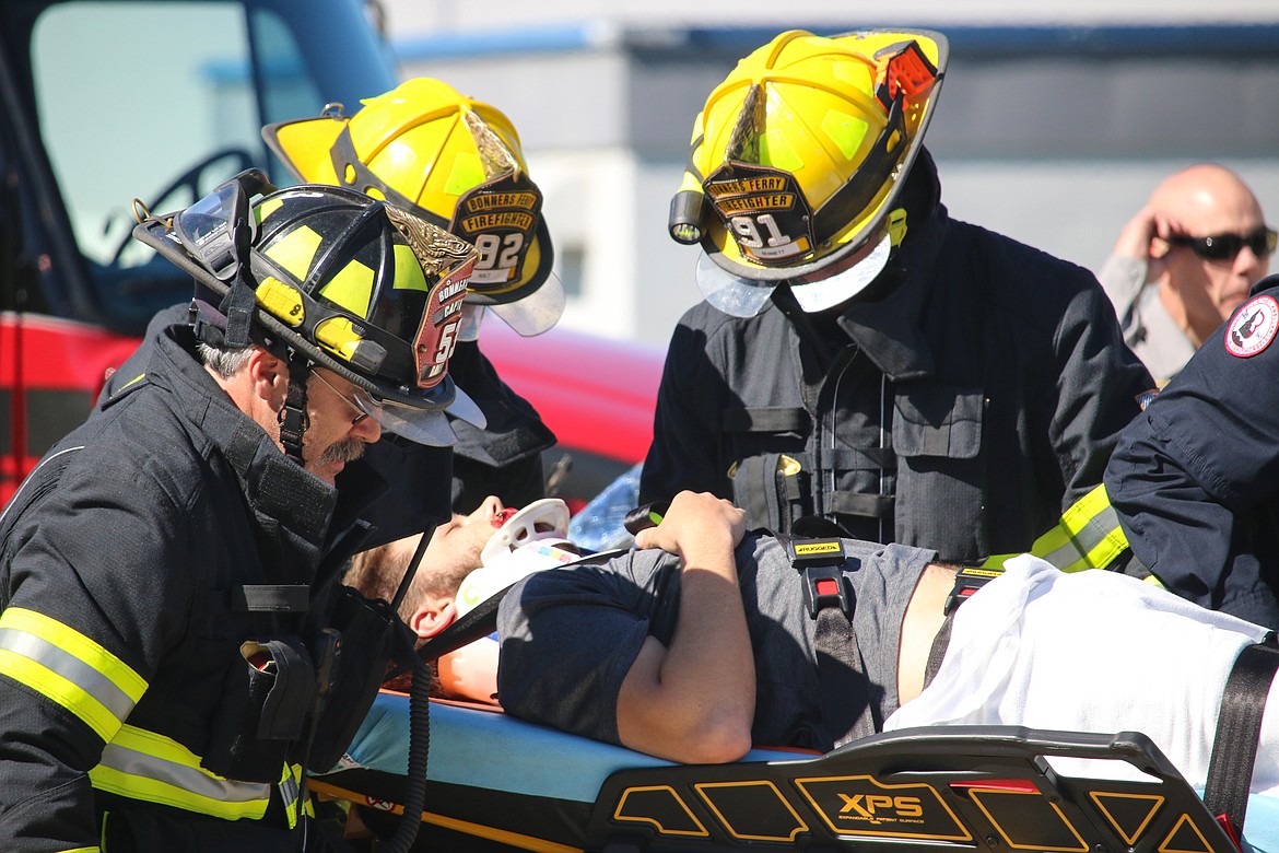 Photo by MANDI BATEMAN
Bonners Ferry City firefighters tend to the simulated crash victim.