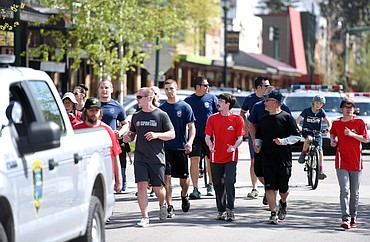 Runners making their way down Central Avenue in Whitefish on Monday, May 8, in Whitefish as part of the Law Enforcement Torch Run for Special Olympics.(Brenda Ahearn/Daily Inter Lake)