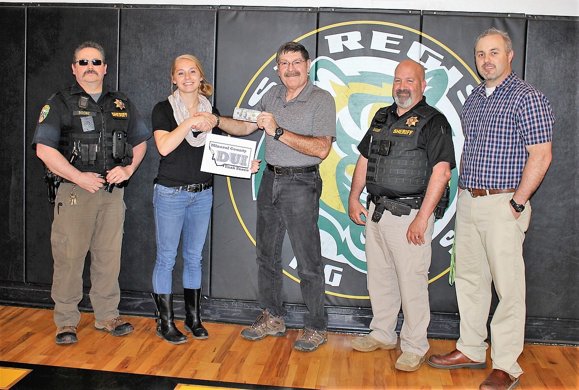 St. Regis senior Madison Hill won the DUI Task Force logo contest. She won the $100 prize and her artwork will be used for task-force advertising campaigns and other material. Undersheriff Mike Boone, retired Sheriff Ernie Ornelas, Sheriff Tom Bauer and Principal Shaun Ball presented Hill with her award last Thursday. (Kathleen Woodford/Mineral Independent).