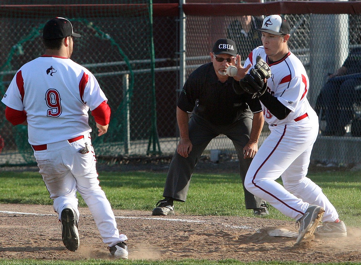 Rodney Harwood/Columbia Basin HeraldOthello pitcher takes the flip from first baseman Jay Rodriguez on a play at first in the third inning of Tuesday's District 5-6 playoff game at Huskies Field.