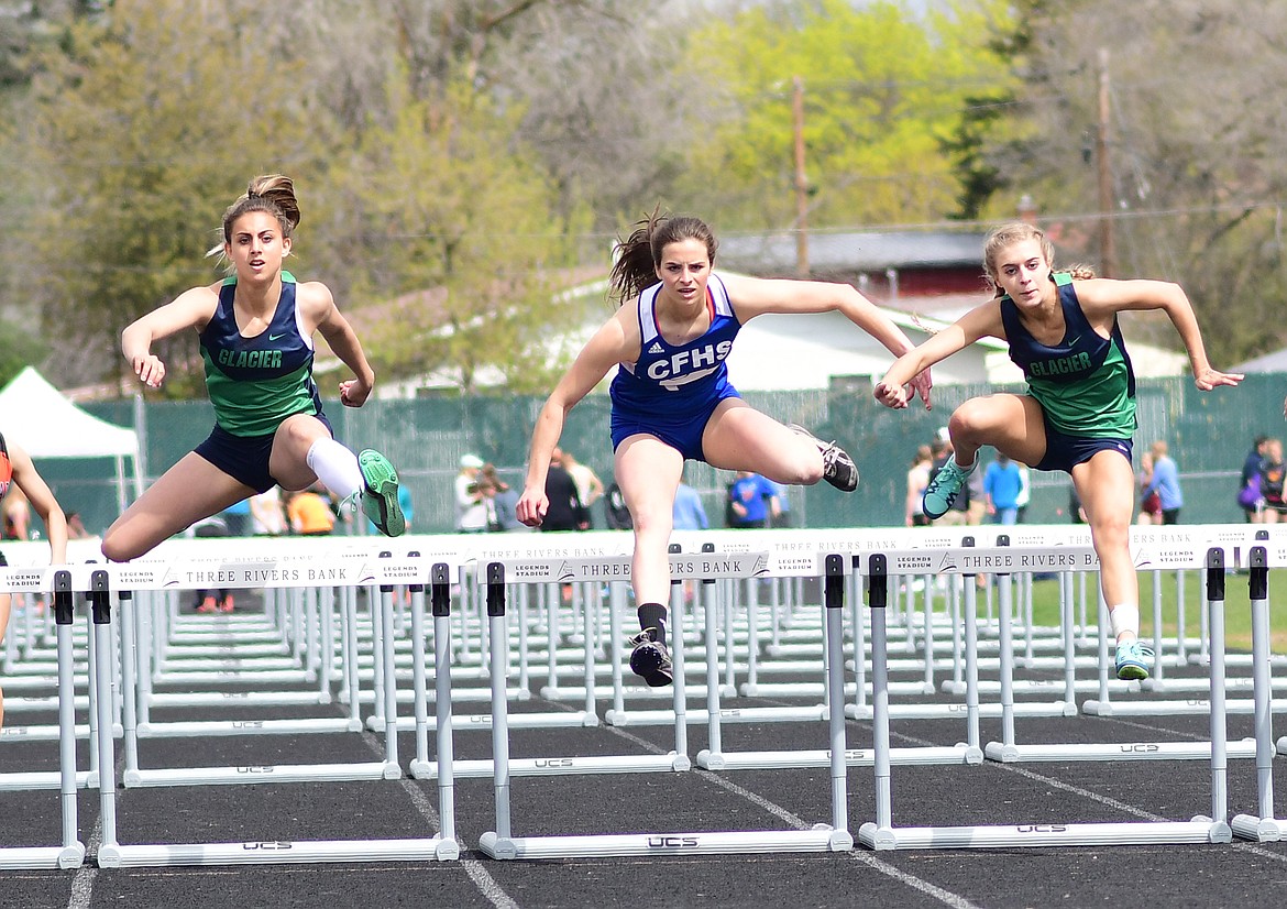 Kaitlyn Casazza, center, would take second by a fraction of a second in the 100 meter hurdles at Archie Roe.