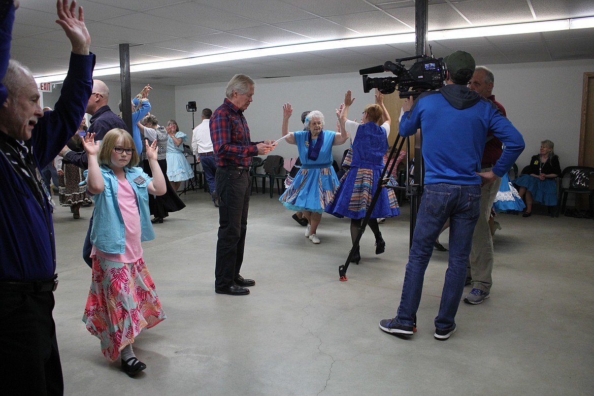 WILLIAMS MARCUS, host of &#147;Backroads of Montana,&#148; does his stand-up for the show in the basement of the First Security Bank in Plains during the club&#146;s square dance.