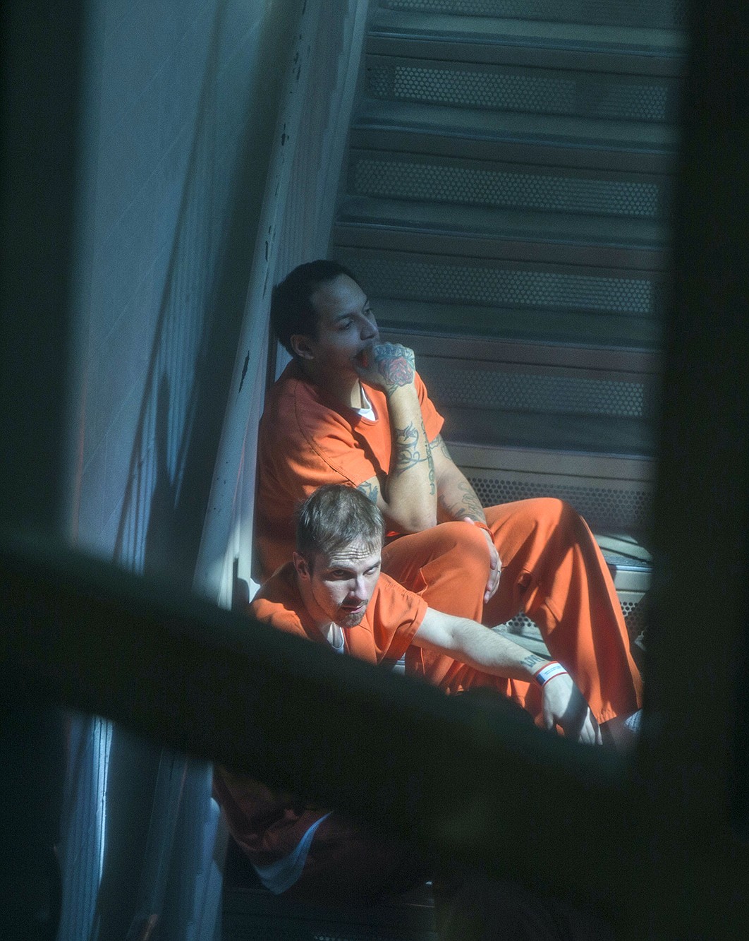 LISA JAMES/PressKootenai County Jail inmates sit in a shaft of sunlight away from the group on April 3. The jail has been at maximum capacity in 2017. County commissioners voted Thursday on the budget for a jail expansion project.