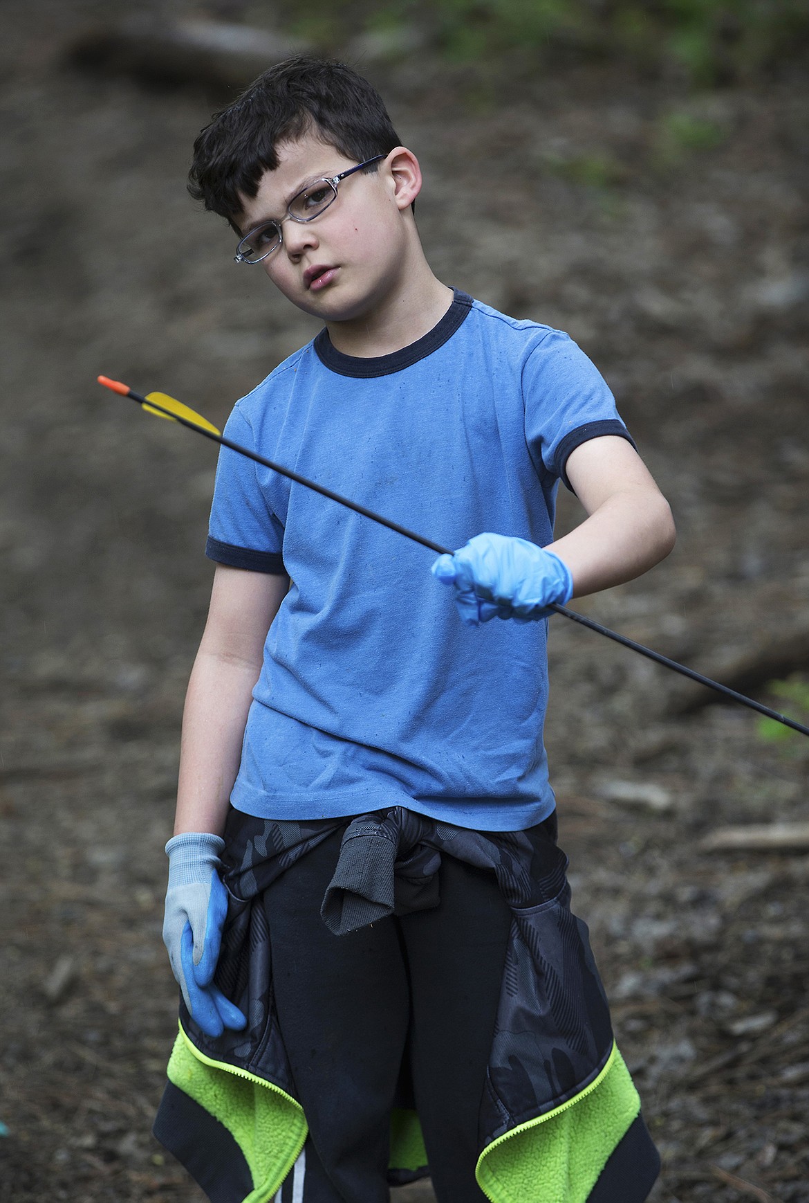 LISA JAMES/Press
John Brown Elementary School first- grader Jared Deem shows off a broken arrow he found during a litter cleanup with his class on Thursday, May 18.
Local environmental activist Dylan Stiegemeier, who started The Theodores, went out with students and teachers to clean up a patch of woods near the school, after teaching them about littering and recycling.