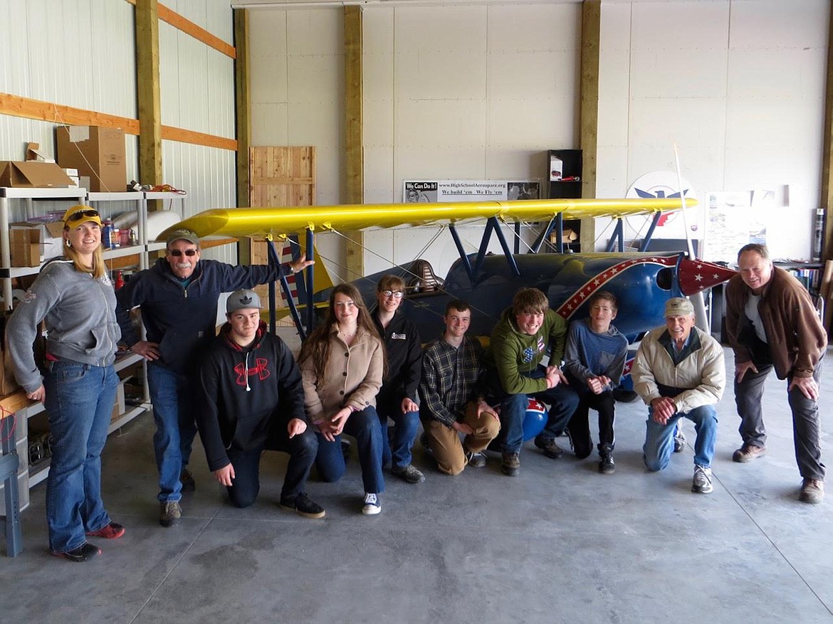 (Courtesy photo)
North Idaho High School Aerospace Program participants and organizers recently got together to thank local aviator Chuck Chehock who generously donated his bi-plane to the group. In the 1940s, Chuck lived on a farm in Iowa and learned to fly as a teenager. He hopes his gift will inspire area young people to develop the lifelong love of aviation he&#146;s enjoyed. The North Idaho High School Aerospace program helps local students prepare for careers in the aerospace industry by providing hands-on aviation mechanic and flight training opportunities. For information about the program, go online to highschoolaerospace.org. Pictured, from left, are Amber Phillips, Glen Smith, Joshua Kramer, Lilly Falconer, Eleanor Falconer, Daniel Spencer, Ron Korn, Alex Liddiard, Chuck Chehock, and Barney Ballard.