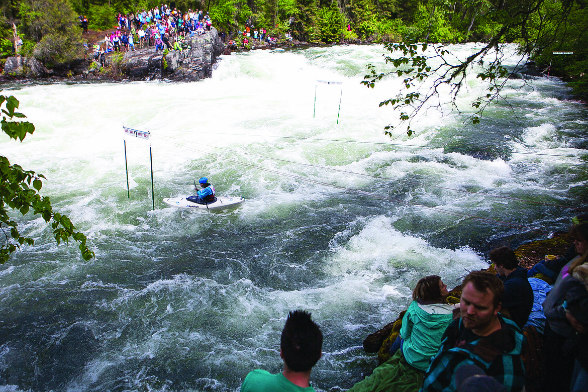 SPECTATORS GATHER on both sides of the river to watch expert slalom runs afternoon during the 2014 Bigfork Whitewater Festival on the Swan River. (Patrick Cote/Daily Inter Lake, file)