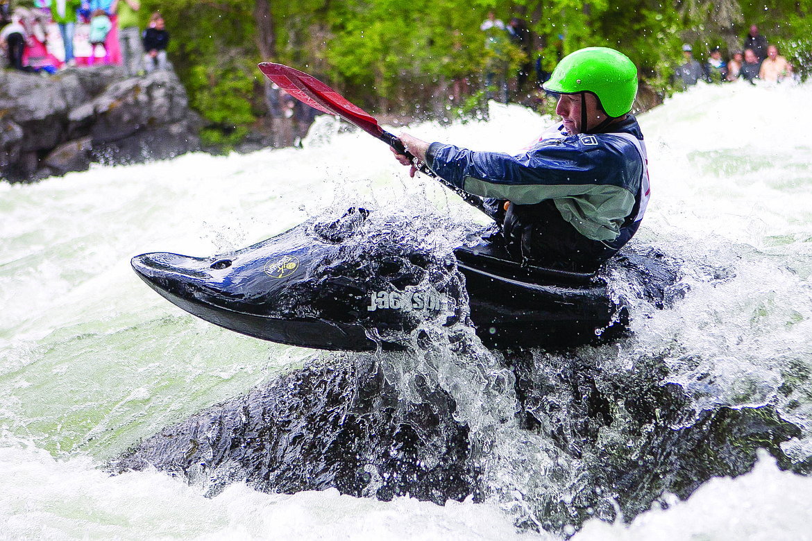 A COMPETITOR launches off a rock during expert slalom runs at the 39th annual Bigfork Whitewater Festival in 2014. (Patrick Cote/Daily Inter Lake, file)