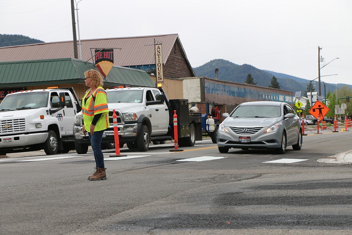 (Photo by CAROLINE LOBSINGER)
A flagger guides traffic as Idaho Transportation Department crews put the finishing touches before today&#146;s switching of Fifth Avenue back to two-way traffic.