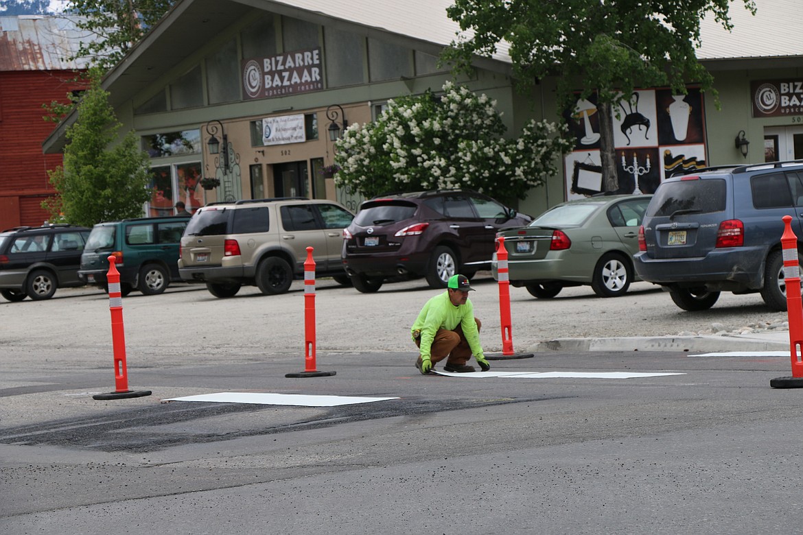 (Photo by CAROLINE LOBSINGER)
A member of the Idaho Transportation Department lays down reflection crosswalk strips on Church Streets as crews put the finishing touches before today&#146;s switching of Fifth Avenue back to two-way traffic.