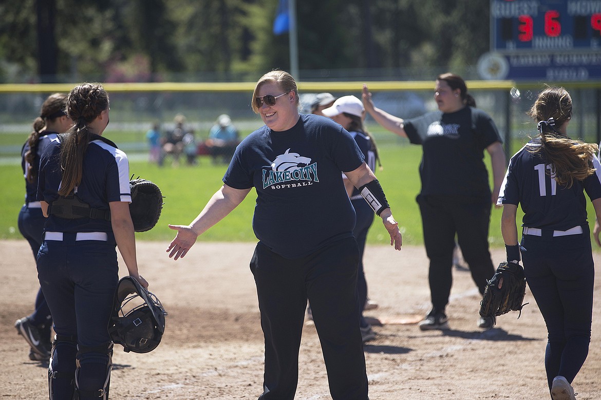 LISA JAMES/PressLake City assistant coaches Amanda Krier, front, and Janey Ortega give players high-fives and a pop talks as they are down 9-3 in the 6th inning of their first game of the 5A State Championship against Eagle at Coeur D'Alene High School on Sunday.