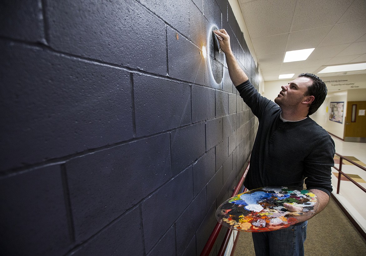 LOREN BENOIT/Press
Local artist Jason Sanchez paints a galaxy mural in the front hallway of Ramsey Magnet School of Science last week. Sanchez, a disabled Army veteran, has been spending several hours each weeknight since mid-April to complete the solar system mural at no cost to his childhood school. He plans to have it done in early June.