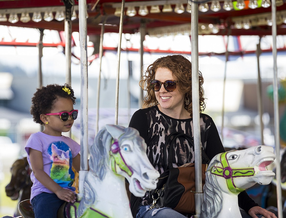 LOREN BENOIT/Press

Karena Thomason and Lucia, 3, ride the Wisdom Carousel at Spring Fest on Saturday. Spring Fest runs from 10 a.m. to 4 p.m. on Sunday at the Kootenai County Fairgrounds.