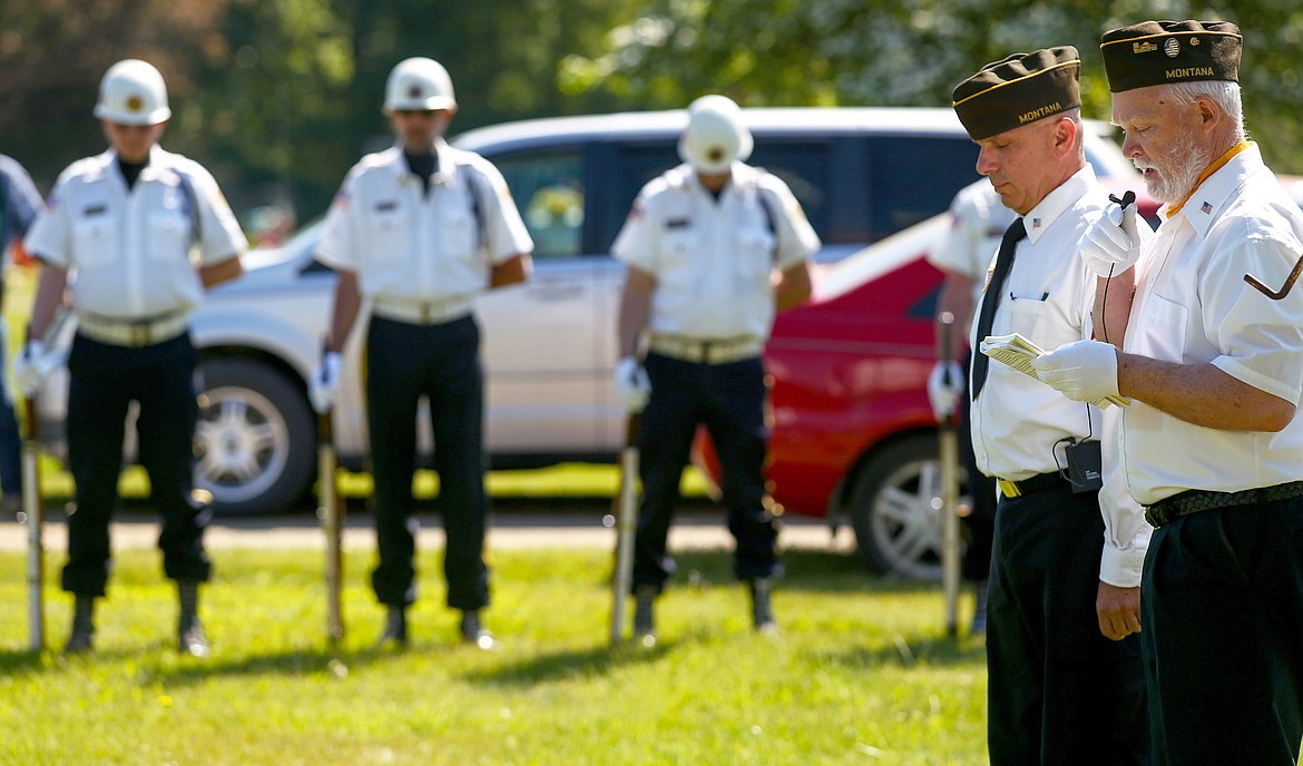 John Beebe, right, prays as Cmdr. Gary Zoutte to his left and the honor guard in the background bow their heads during a Memorial Day ceremony at Libby Cemetery Monday, May 29, 2017. (John Blodgett/The Western News)