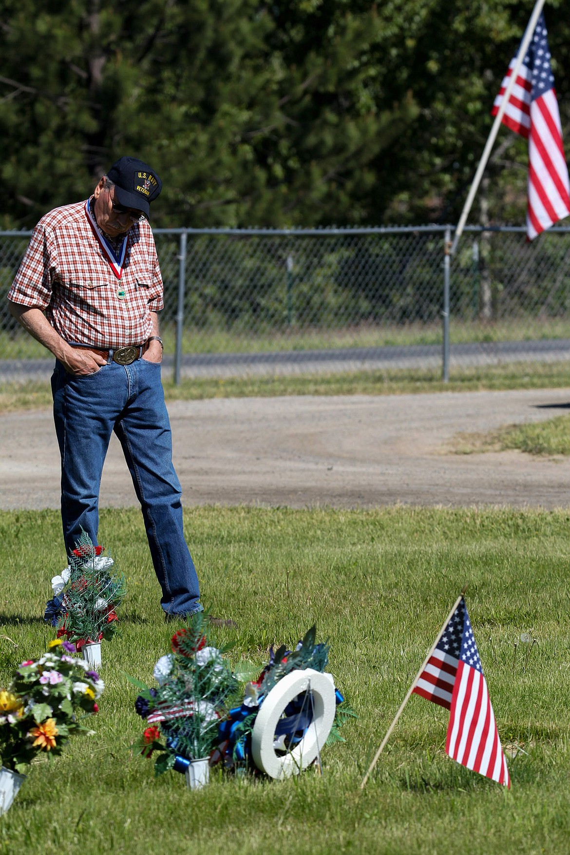 U.S. Navy veteran Bill Silva of Libby visits graves before a Memorial Day ceremony at Libby Cemetery Monday, May 29, 2017. (John Blodgett/The Western News)