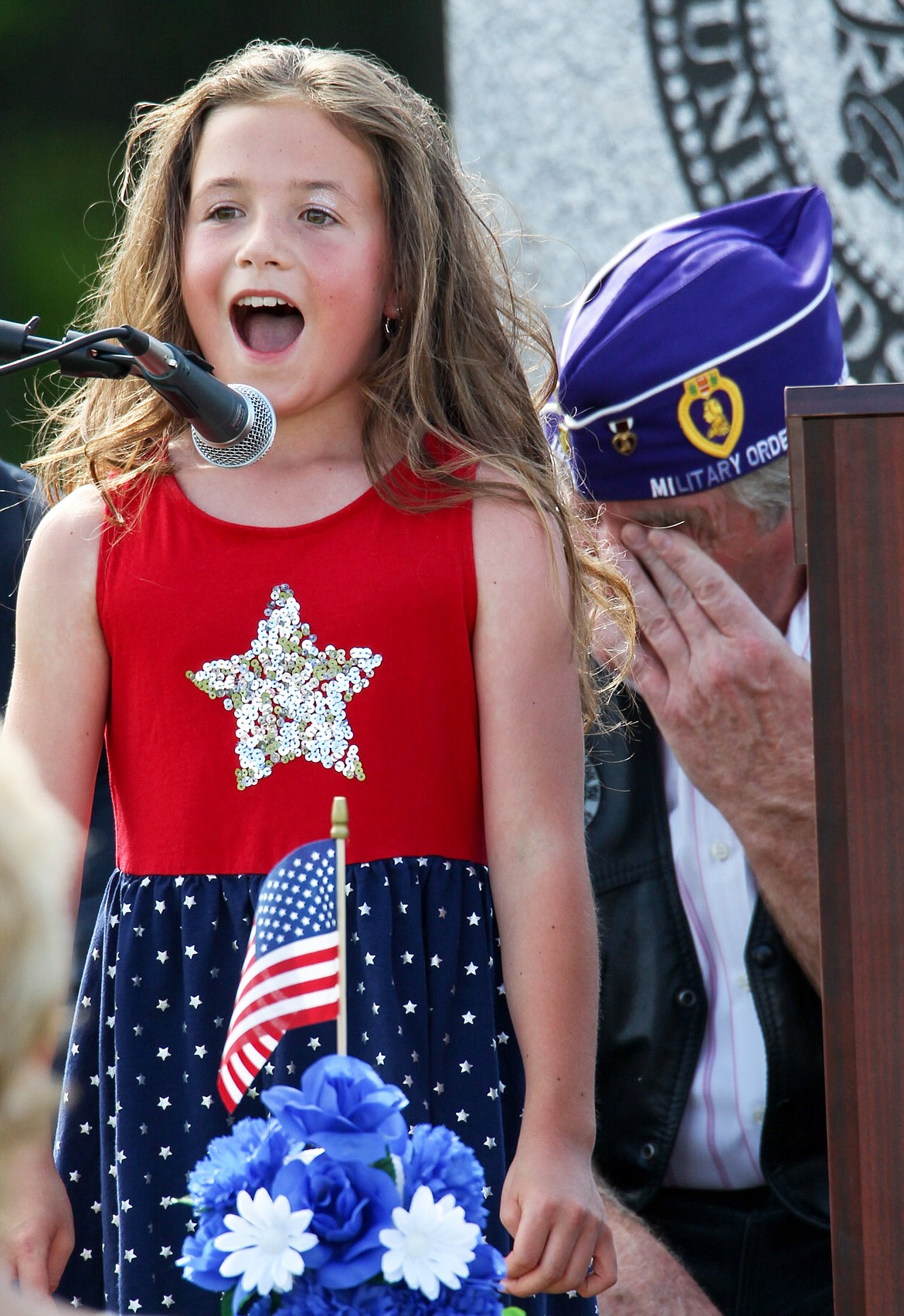Madison Vincent, 10, sings &#147;Didn&#146;t I?&#148; by Montgomery Gentry at a Memorial Day ceremony at the Veterans Memorial in Libby Monday evening, May 29, 2017. (John Blodgett/The Western News)