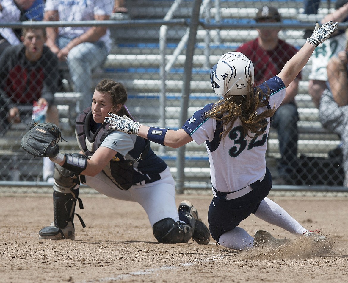 LISA JAMES/Press
Meridian catcher Ashley Brink (?) tries to tag out Lacey Lemburg of Lake City as she slides into home plate during the 5th inning of the first of the 5A State Championship games at Coeur D&#146;Alene High School on Friday. Meridian lost 8-2  to Lake City.