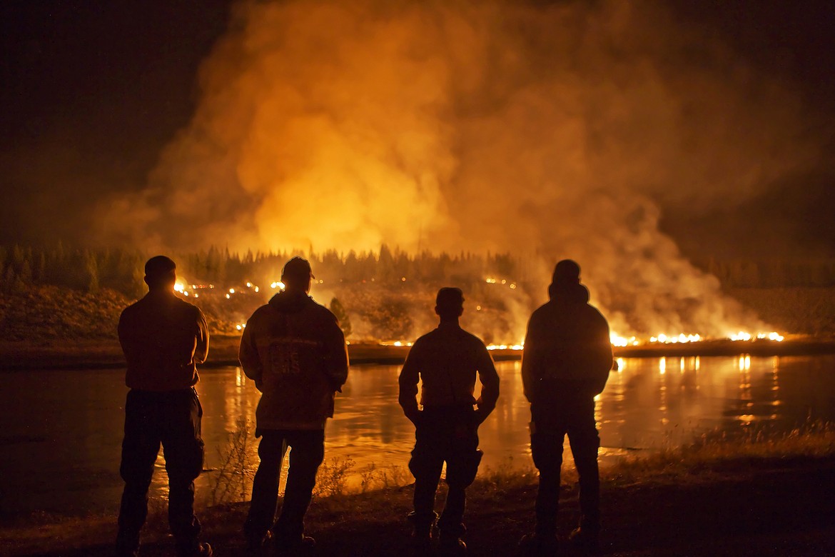 FIREFIGHTERS KEEP watch on a wildfire inside Yellowstone National Park in 2016. All residents throughout Montana are encouraged to participate in Wildfire Awareness Month this May. (Jeremy Weber/Clark Fork Valley Press)