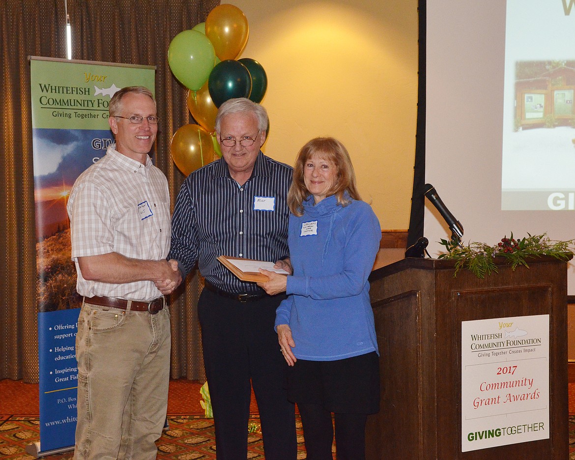 Mike Jenson, center, presents Mike Koopal and Lori Curtis with the Whitefish Lake Institute the Russ and Mary Jane Street Community Service Award.